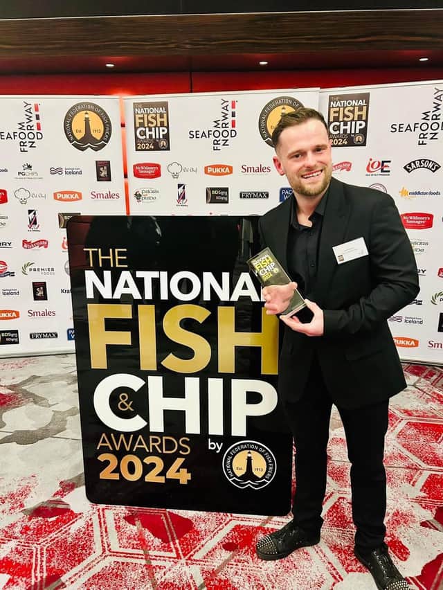 Jamie Toland proudly shows off his Employee of the Year award at the National Fish and Chip Awards 2024. 