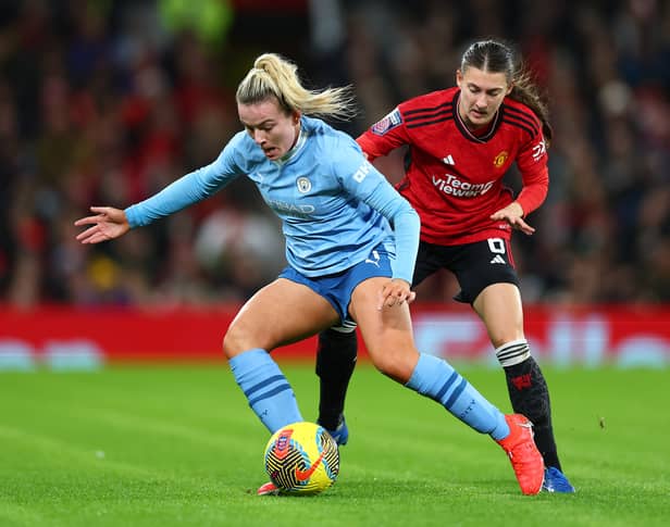 Lauren Hemp is challenged by Hannah Blundell during City's win at Old Trafford last November.