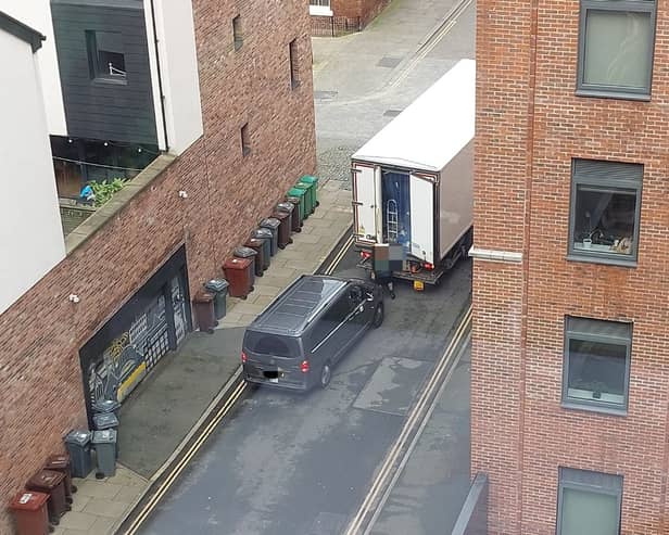 The moment the taxi driver reportedly drove at the delivery man. Image: John Smith.