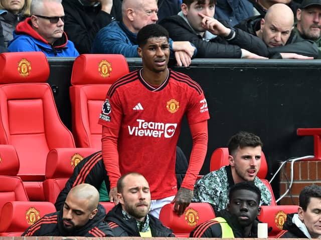 Marcus Rashford looks on from the dugout after being substituted