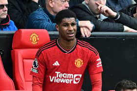 Marcus Rashford looks on from the dugout after being substituted