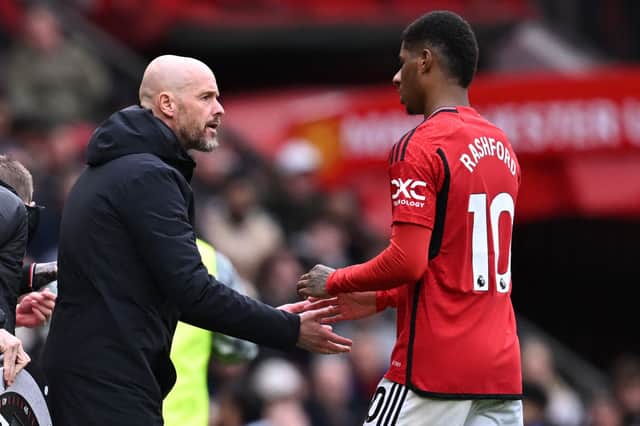Erik ten Hag speaks with Marcus Rashford as he is substituted