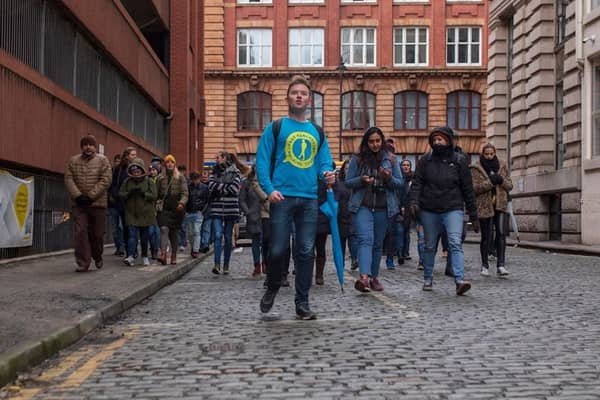 Josh Martin leading a group on one of his Manchester walking tours. Credit: Josh Martin