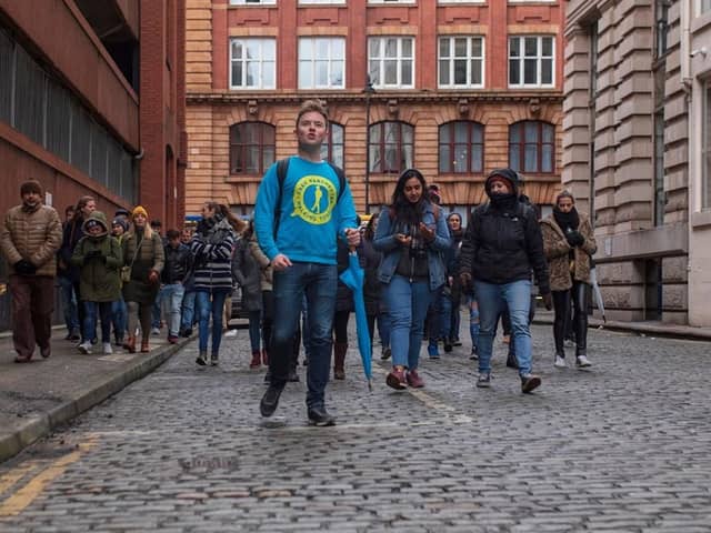 Josh Martin leading a group on one of his Manchester walking tours. Credit: Josh Martin