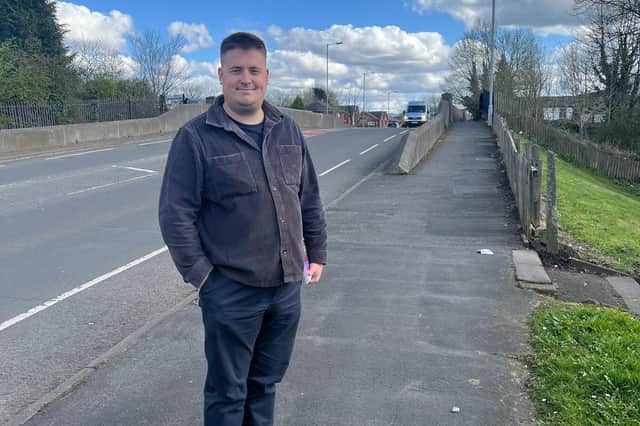 Coun John Blundell, representative for Smallbridge and Firgrove, stood on the bridge over the Calder Valley Line.