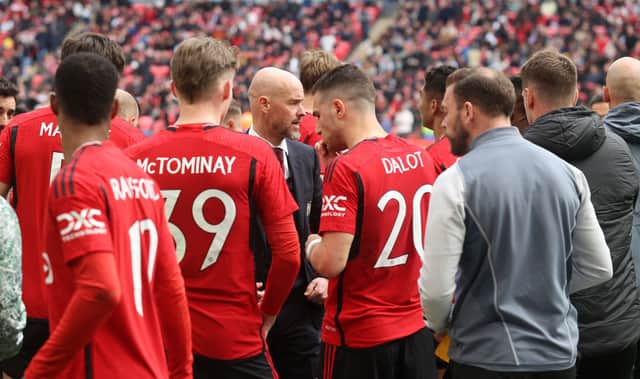 Erik ten Hag talks to the players ahead of the penalty shootout win