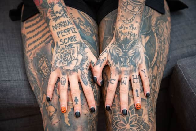 Sarah Hutchinson's hands covered in tattoos