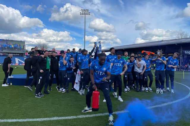 Stockport County's players celebrate promotion at Edgeley Park 