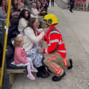 Newly qualified firefighter James proposing to his girlfriend. 