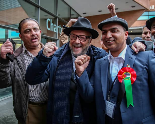 George Galloway arrives to congratulate fellow Workers Party of Britain candidate Shahbaz Sarwar (second right) during the Manchester city council election results on May 3. Credit: William Lailey / SWNS