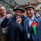 George Galloway arrives to congratulate fellow Workers Party of Britain candidate Shahbaz Sarwar (second right) during the Manchester city council election results on May 3. Credit: William Lailey / SWNS