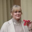 Actress Sarah Lancashire poses after she was awarded an OBE by Duke of Cambridge