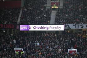The LED board shows VAR checking for a penalty during the Premier League match between Manchester United and Manchester City at Old Trafford