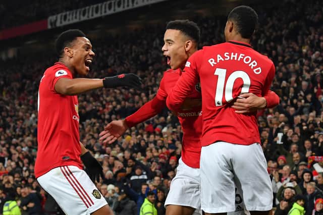 Mason Greenwood celebrates with Anthony Martial and Marcus Rashford