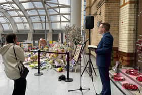 Railway chaplain Mike Roberts leads the service for the Manchester Arena attack victims at Victoria Station