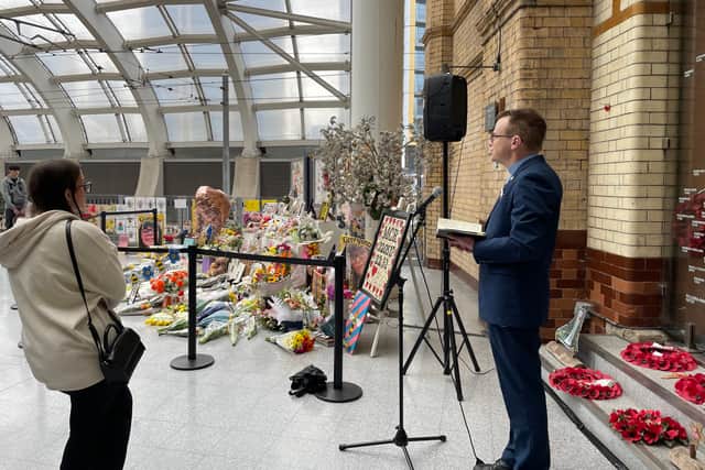 Railway chaplain Mike Roberts leads the service for the Manchester Arena attack victims at Victoria Station