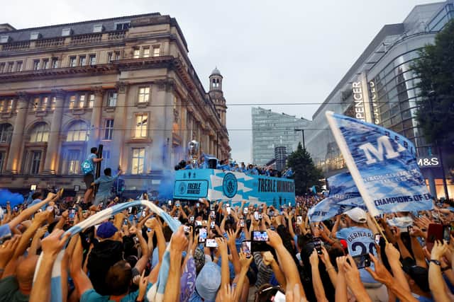 Manchester City players celebrate on the open top bus during the Manchester City trophy parade on June 12, 2023 in Manchester, England. (Photo by George Wood/Getty Images)