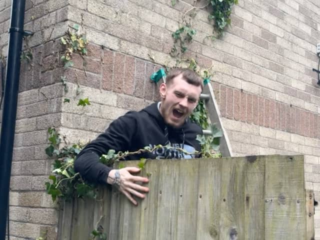 Amusing moment Tyla Shellard, 21, falls from an ivy branch whilst helping to clear a friends garden in Cardiff ready for summer, May 21 2024. 