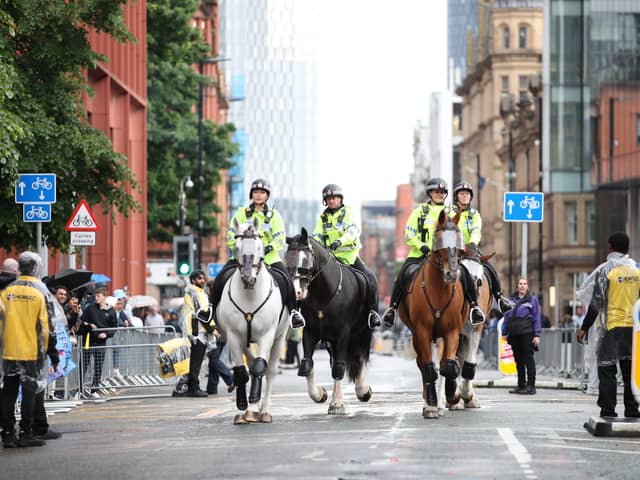 Mounted police patrol the area prior to the Manchester City trophy parade on Sunday