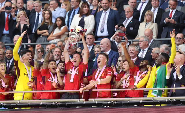 Jonny Evans lifts the FA Cup after victory over Man City