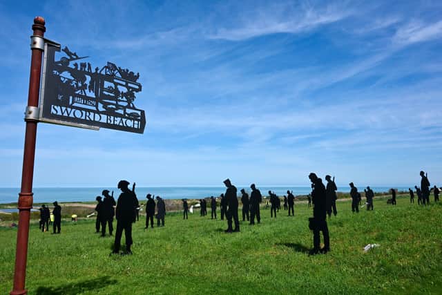 Silhouettes of soldiers installed as part of the "Standing with Giants" installation at the World War II British Normandy Memorial 