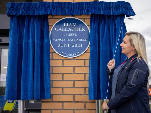 Emma, a staff member at Lidl, as a blue plaque is unveiled by Lidl's Newton Heath store in Manchester to honour the Liam Gallagher concert that almost was. 