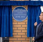 Emma, a staff member at Lidl, as a blue plaque is unveiled by Lidl's Newton Heath store in Manchester to honour the Liam Gallagher concert that almost was. 