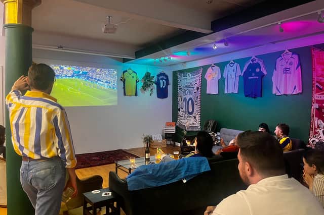 Ukraine fans watch the national team's group match against Slovakia in the 2024 Euros at Stunner vintage football shirt shop in Manchester. 