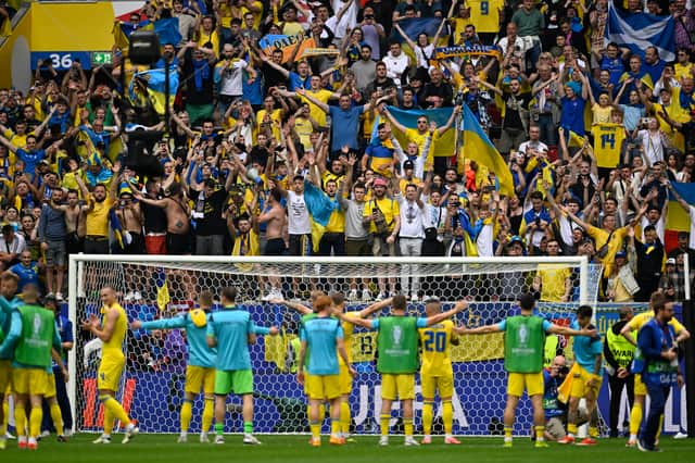 The Ukraine players celebrate with their fans after the win against Slovakia. 