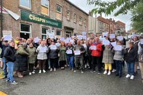 The protesters outside the Crispin Arms in Scholes, Wigan
