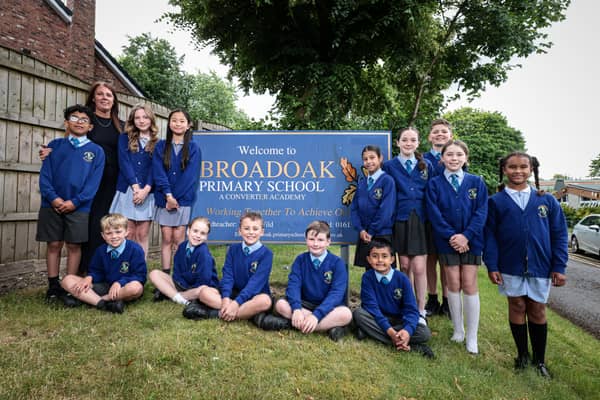 Head teacher, Karen Wild, and pupils from Broadoak primary school, celebrate being rated 'outstanding' in a recent Ofsted inspection.