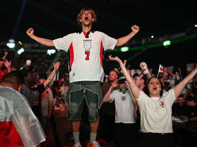 A fan celebrates Harry Kane's first-half equaliser from the penalty spot. 
