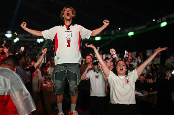 A fan celebrates Harry Kane's first-half equaliser from the penalty spot. 