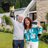 Darren & Rachael Reid - Omaze Million Pound House Surrey winners outside their new £3m home 