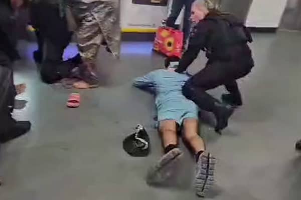 A screen-grab from a video that shows a man being kicked by GMP officers at Manchester Airport 