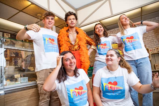 Ben McCormick, 16, Imogen Ford, 22, Gillian Calbi, 24, Chloe Thomason, 22, and Carys Holt, 19, with waxwork Harry inside W. Mandeville Bakery.