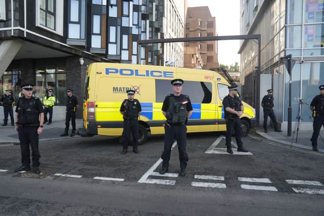 Police officers and a police van block the vehicle entrance at Liverpool Magistrates' Court where a 17-year-old boy, who cannot be named for legal reasons, is appearing charged with three counts of murder, 10 counts of attempted murder and possession of a bladed article, following a knife attack at a Taylor Swift-themed holiday club in Southport on Monday. Credit: Danny Lawson/PA Wire