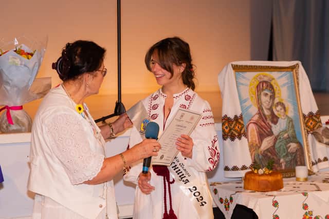 Sofia Chymera receives her certificate from the head of exams at Manchester Ukrainian School Maria Sawdyk. Credit: Maryna Seletska.