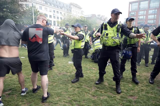 Police try to restore order in Piccadilly Gardens on Saturday.