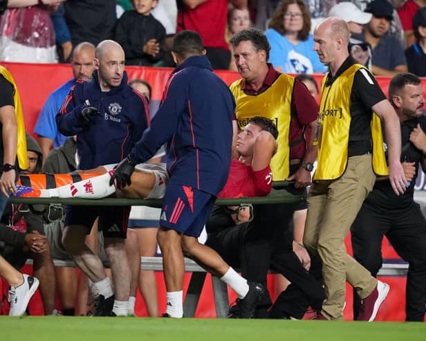 Will Fish is stretchered off during Man Utd's 3-0 defeat by Liverpool.