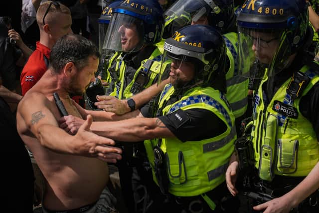 Police clash with right-wing protesters in Manchester's Piccadilly Gardens (Picture: Christopher Furlong/Getty Images)