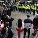 Police form a divide between people taking part in an anti-racism counter protest