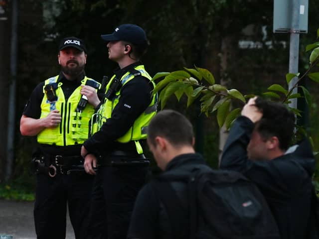 Police attended the scene and many on-lookers at the planned protest near SWAP (Support for Wigan Arrivals Project), Penson Street, Wigan.