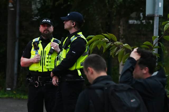 Police attended the scene and many on-lookers at the planned protest near SWAP (Support for Wigan Arrivals Project), Penson Street, Wigan.
