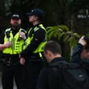 Police attended the scene and many on-lookers at the planned protest near SWAP (Support for Wigan Arrivals Project), Penson Street, Wigan.