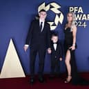 Manchester City's Phil Foden poses on the red carpet with his son Ronnie Foden and his wife Rebecca Cooke Foden 