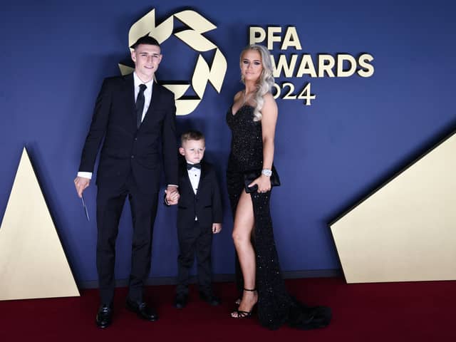 Manchester City's Phil Foden poses on the red carpet with his son Ronnie Foden and his wife Rebecca Cooke Foden 