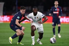 Paris Saint-Germain midfielder Manuel Ugarte (L) fights for the ball with Nice forward Terem Moffi