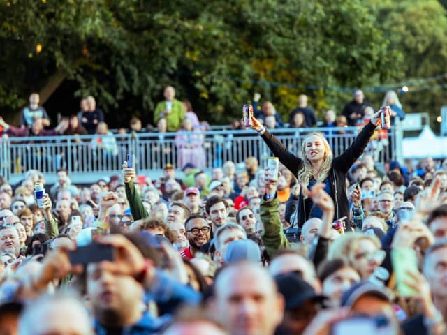 Fans watch Johnny Marr perform at Live From Wythenshawe Park 2024. Credit: Scott M Salt