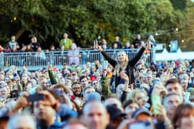 Fans watch Johnny Marr perform at Live From Wythenshawe Park 2024. Credit: Scott M Salt